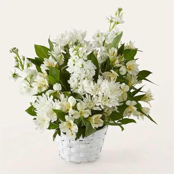 White flowers arranged in a white woven basket