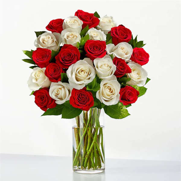 Bouquet of red and white roses in a clear glass vase