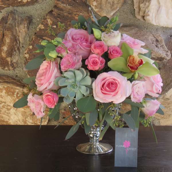 Pink rose bouquet in a silver vase with succulents and greenery