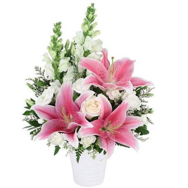 Pink lilies and white roses in a white vase