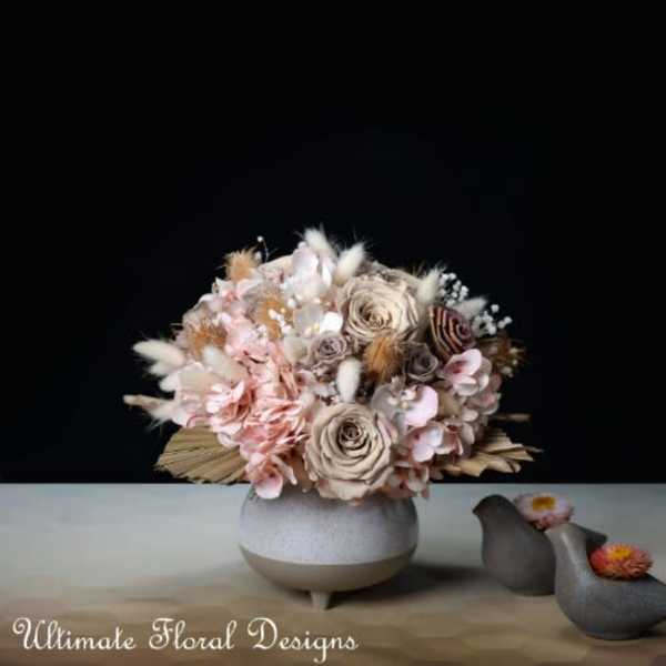 Soft pink and cream bouquet in a round ceramic vase