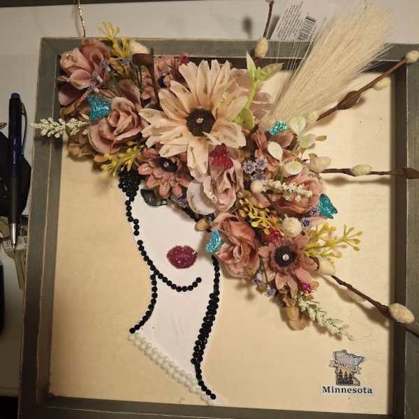 Framed floral silhouette artwork with pink flowers and decorative beads