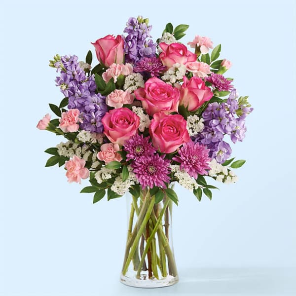 Pink and purple mixed bouquet in a clear glass vase