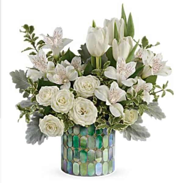 White tulips and roses in a mosaic glass vase