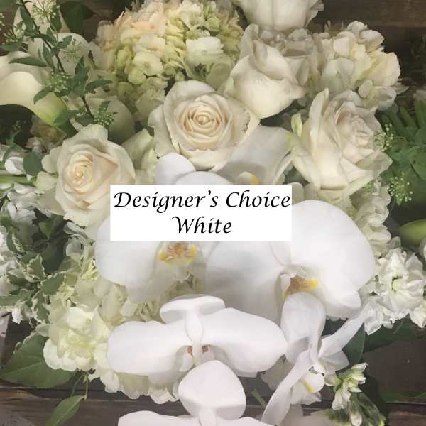 White roses and orchids in a dense floral arrangement