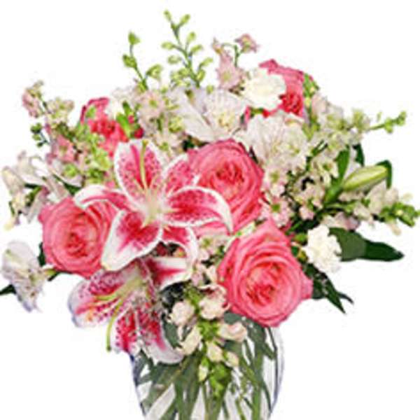 Pink and white mixed flower bouquet in a clear glass vase