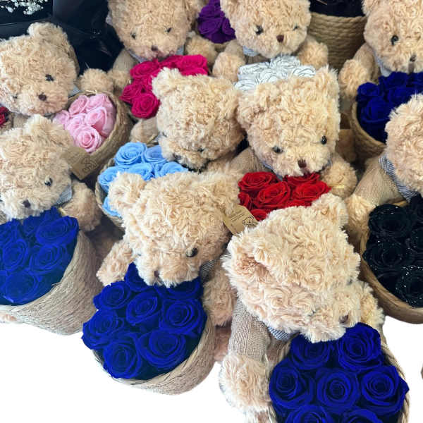 Teddy bears in baskets with roses in assorted colors