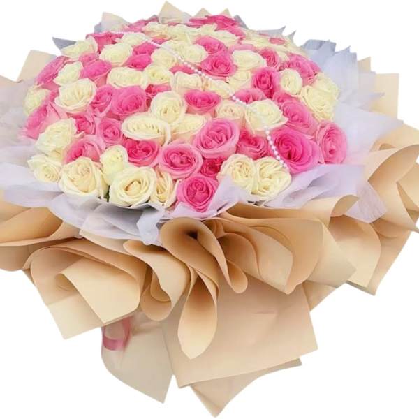 Bouquet of pink and cream roses wrapped in beige paper