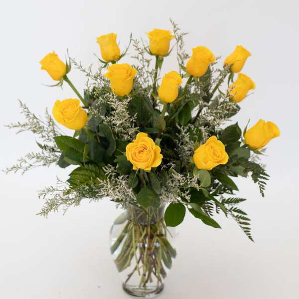 Yellow roses arranged in a clear glass vase