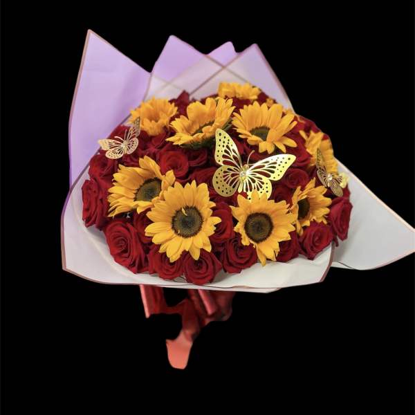 Bouquet of red roses and yellow sunflowers with butterfly decorations