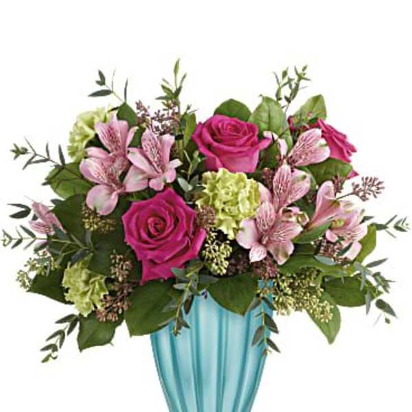 Pink roses and lilies in a blue glass vase