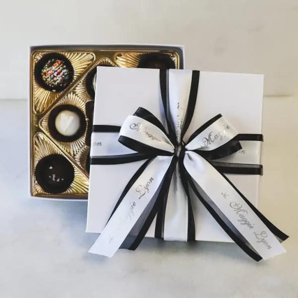Box of assorted chocolates tied with black and white ribbon