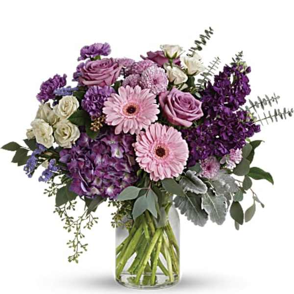 Pink and purple mixed bouquet in a clear glass vase