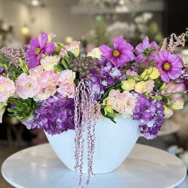 Lavender and pink mixed bouquet in a white textured vase