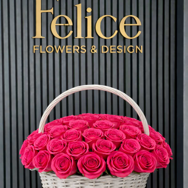 Basket of bright pink roses with a white handle