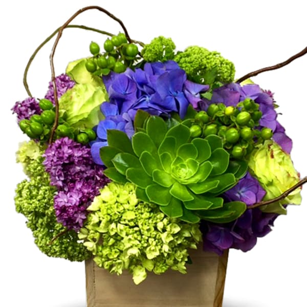 Purple and green floral arrangement in a wooden box