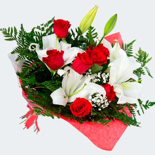 Bouquet of red roses and white lilies wrapped in pink paper