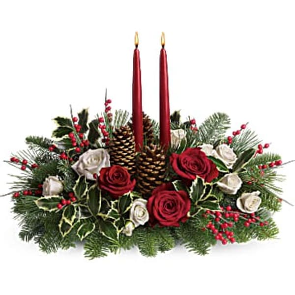 Holiday centerpiece with red candles, roses, pinecones, and evergreen branches