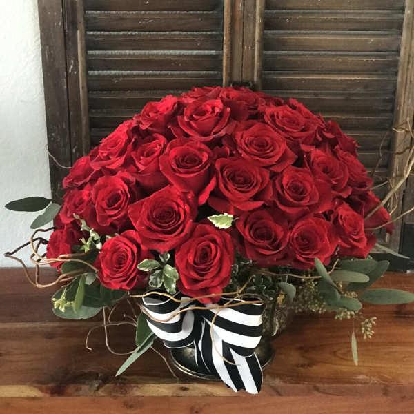 Large bouquet of red roses with a black-and-white ribbon