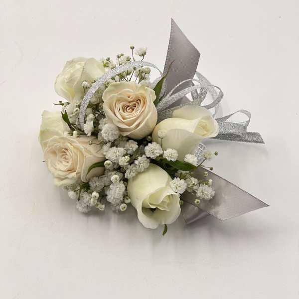 Small bouquet of cream roses and white filler flowers with silver ribbon