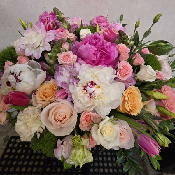 Mixed bouquet of pink, white, and peach flowers