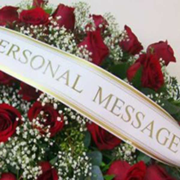 Red roses with baby's breath and a memorial ribbon