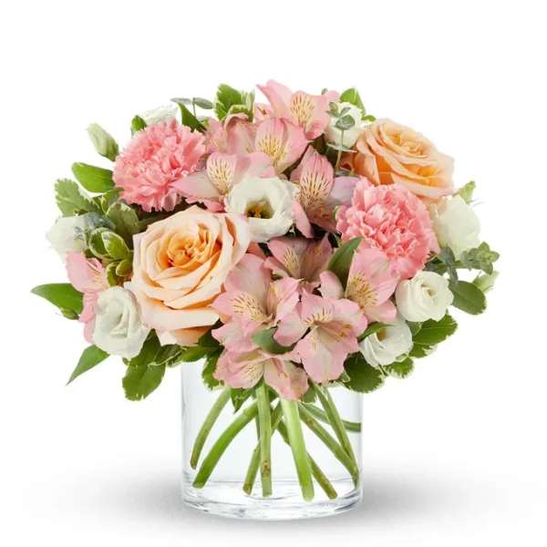 Pink and peach bouquet in a clear glass vase