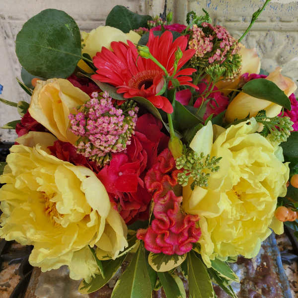 Bouquet of yellow peonies, red gerbera daisies, and pink flowers