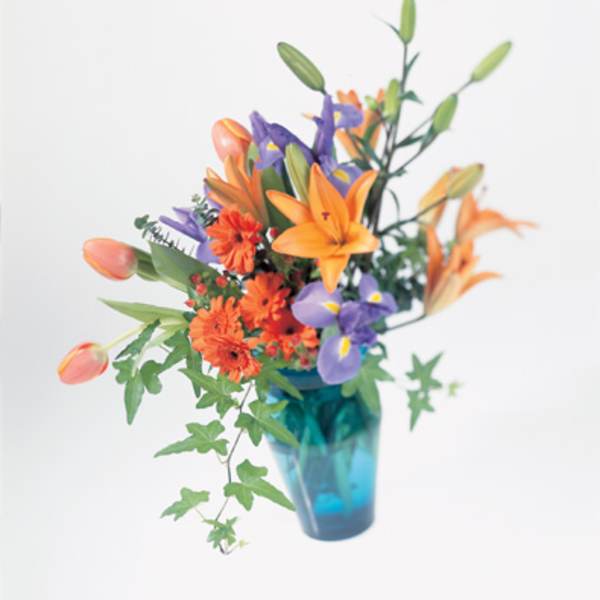 Orange and purple flowers in a blue vase
