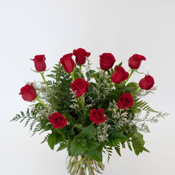 Red roses arranged in a clear glass vase