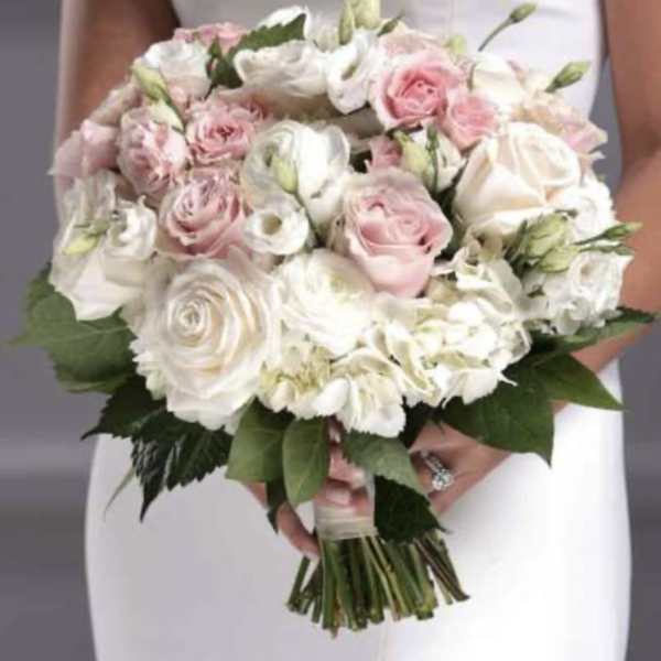 Handheld bouquet of pink and white roses with mixed blooms