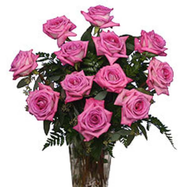 Pink roses arranged in a clear glass vase