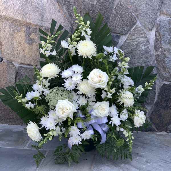 White floral arrangement with roses and chrysanthemums in a vase