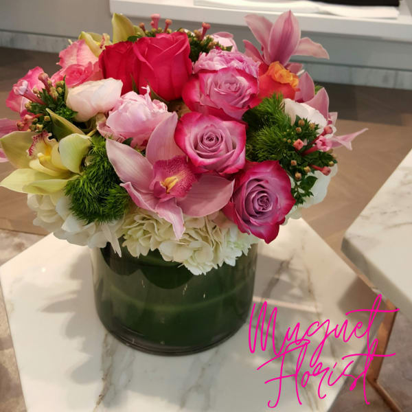 Pink and white mixed bouquet in a dark green vase