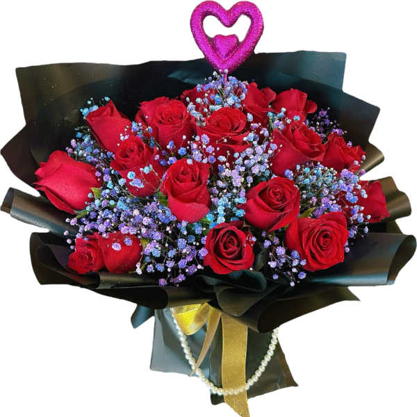 Bouquet of red roses with purple filler flowers in black wrap and a glittery pink heart pick.