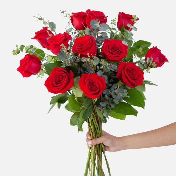 Handheld bouquet of red roses with eucalyptus greenery