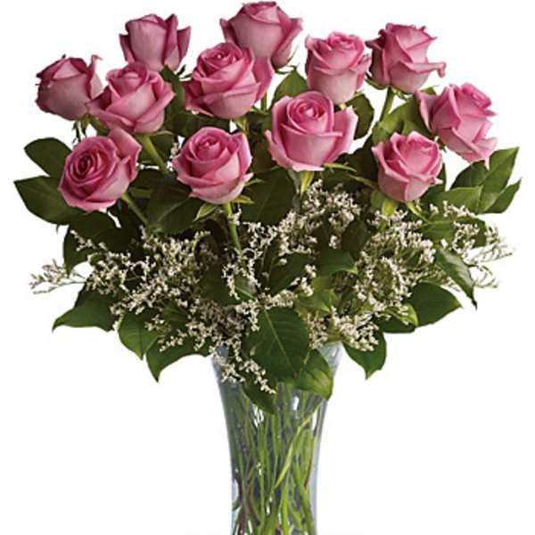 Pink roses arranged in a clear glass vase