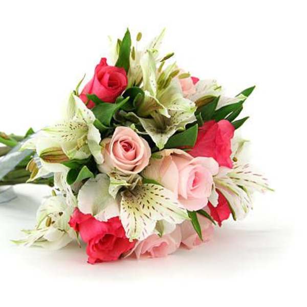 Bouquet of pink roses and white lilies with green foliage