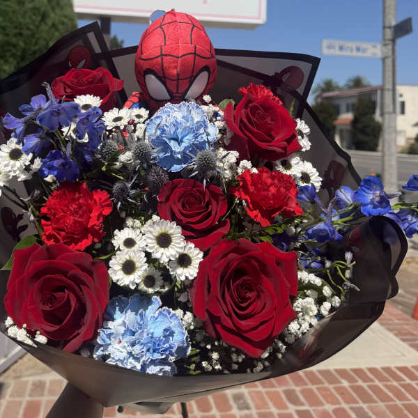 Bouquet of red roses, blue carnations, and white daisies with a Spider-Man plush