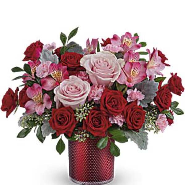 Bouquet of red and pink roses in a red vase