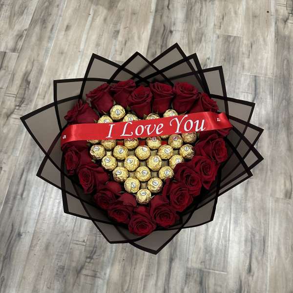 Heart-shaped bouquet of red roses and gold chocolates with an "I Love You" ribbon