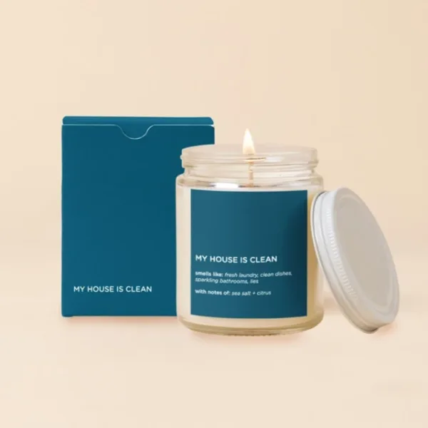 Lit candle in a glass jar with a teal box and lid