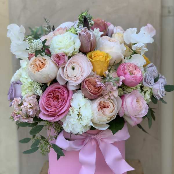 Pink and white rose bouquet in a pink hat box with a satin ribbon
