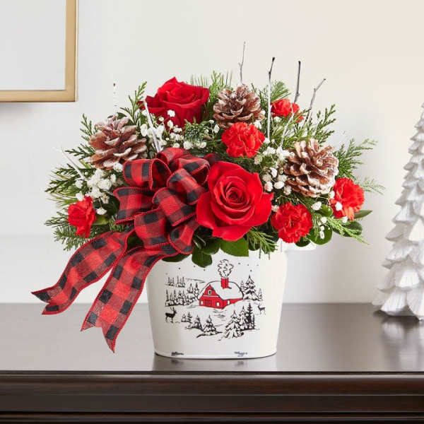 Red roses and carnations in a holiday tin with a plaid ribbon