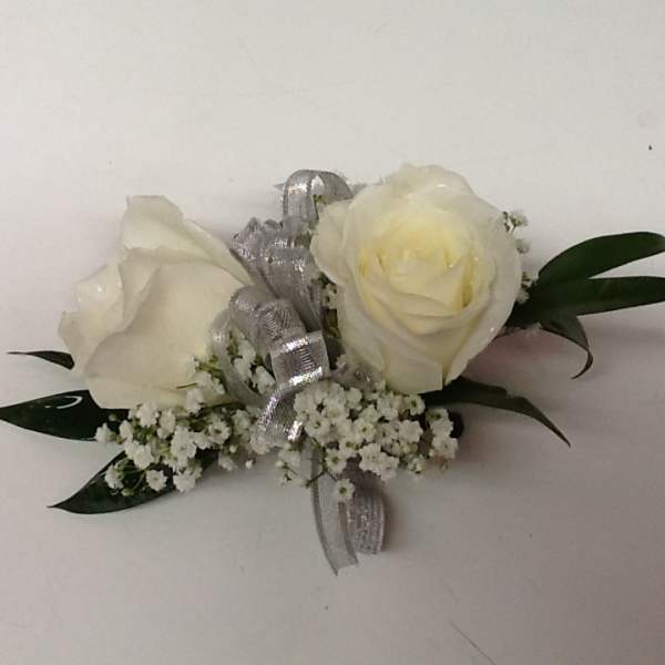 White rose boutonniere with silver ribbon and baby's breath