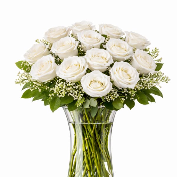 White roses arranged in a clear glass vase
