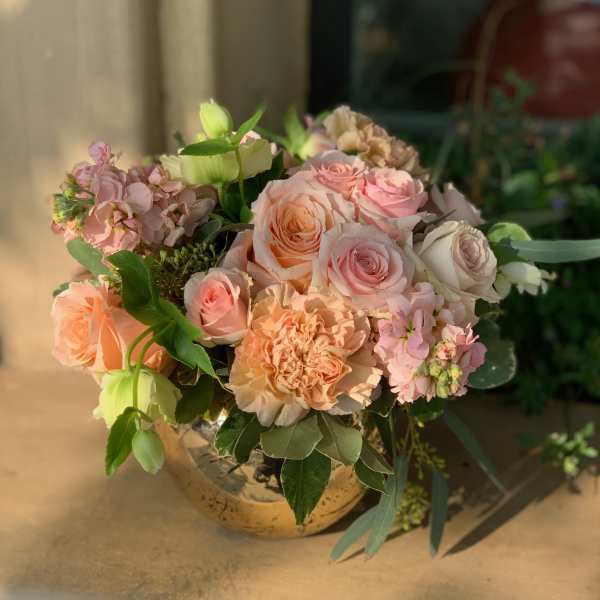 Peach and pink rose bouquet in a round vase