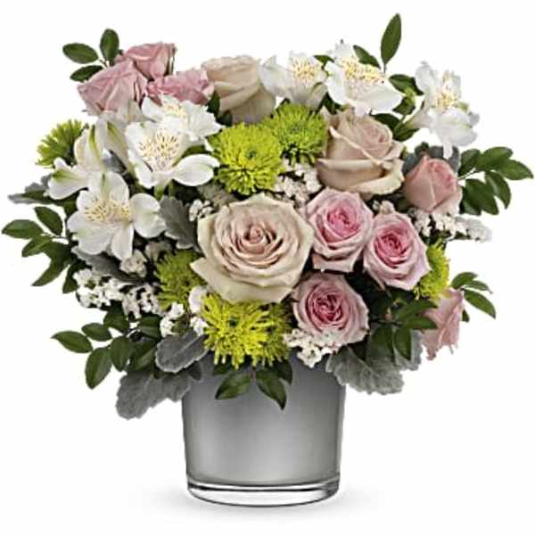 Pink and white roses with white alstroemeria in a glass vase