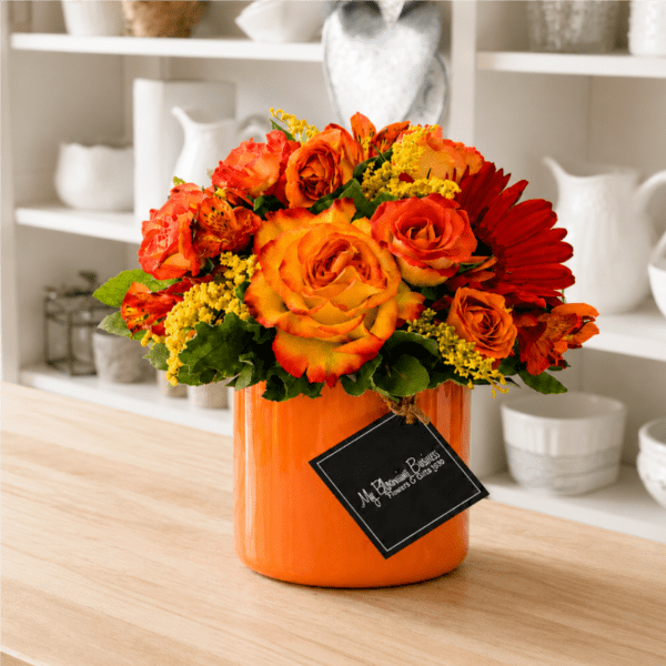 Orange and red rose bouquet in an orange vase