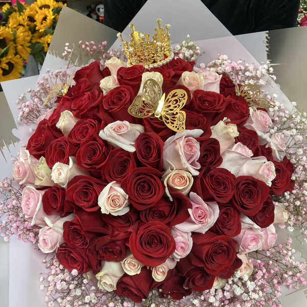Large bouquet of red and pale pink roses with gold butterfly accents